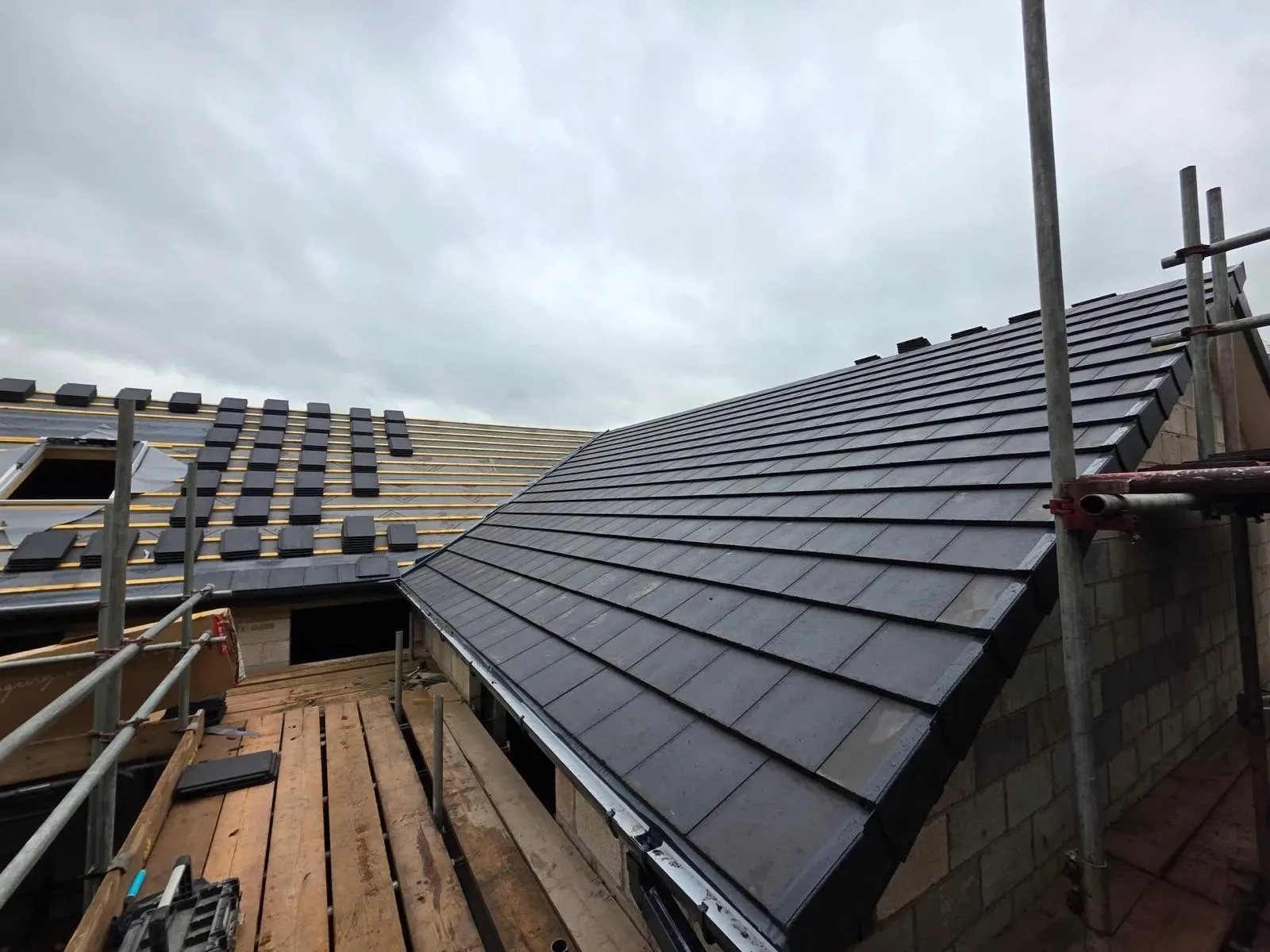 A new build roofed in dark concrete tile, with rooflights, image 14