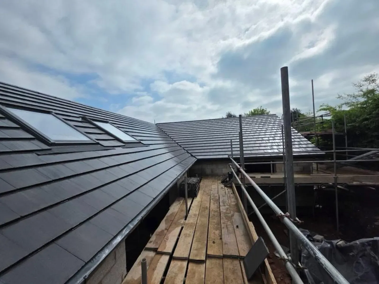 A new build roofed in dark concrete tile, with rooflights, image 9