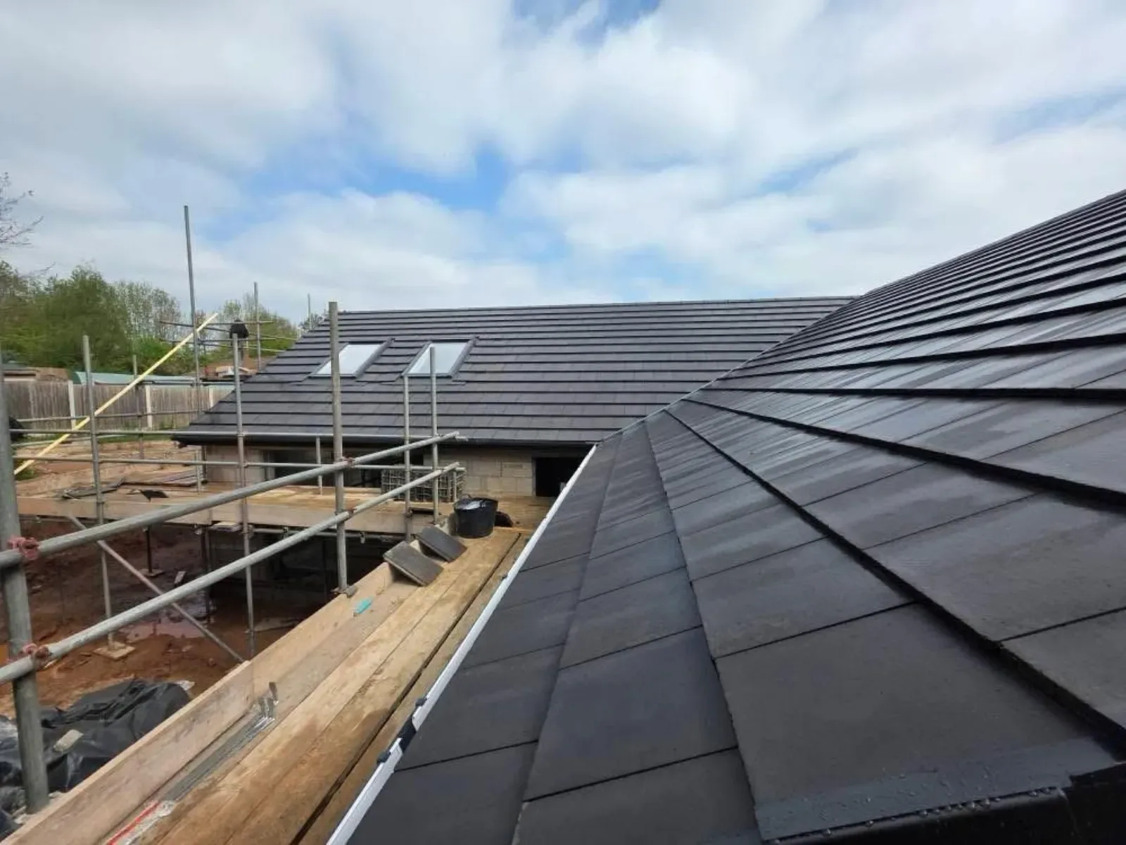 A new build roofed in dark concrete tile, with rooflights, image 7