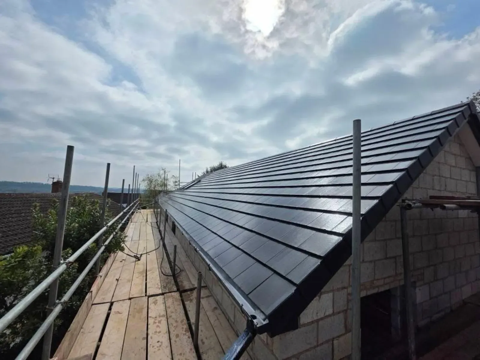 A new build roofed in dark concrete tile, with rooflights, image 5
