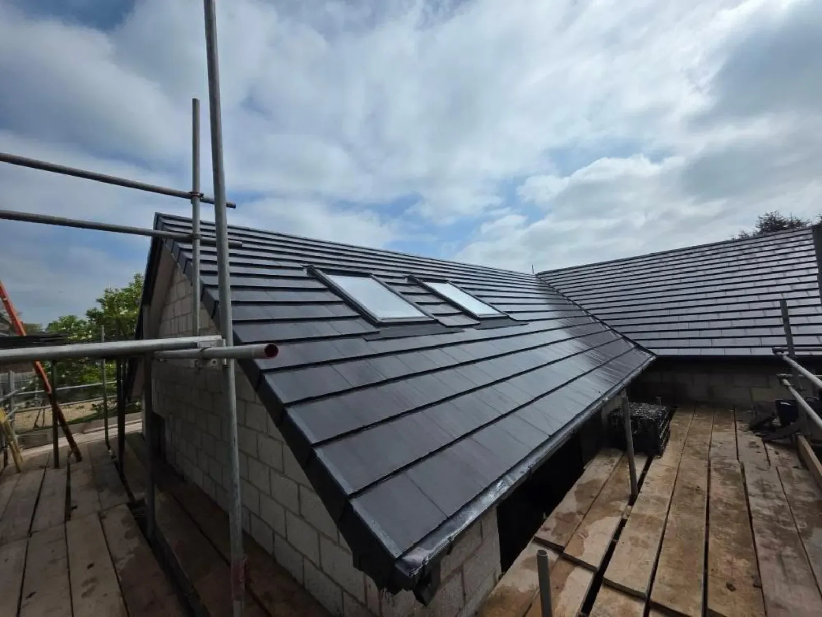 A new build roofed in dark concrete tile, with rooflights, image 8
