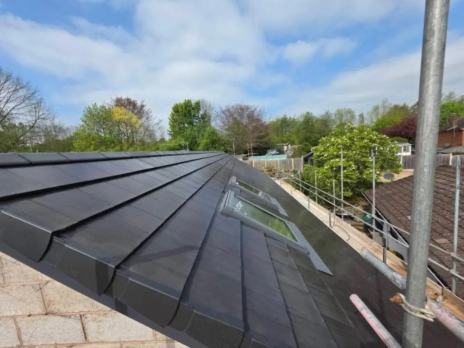 A new build roofed in dark concrete tile, with rooflights, image 12