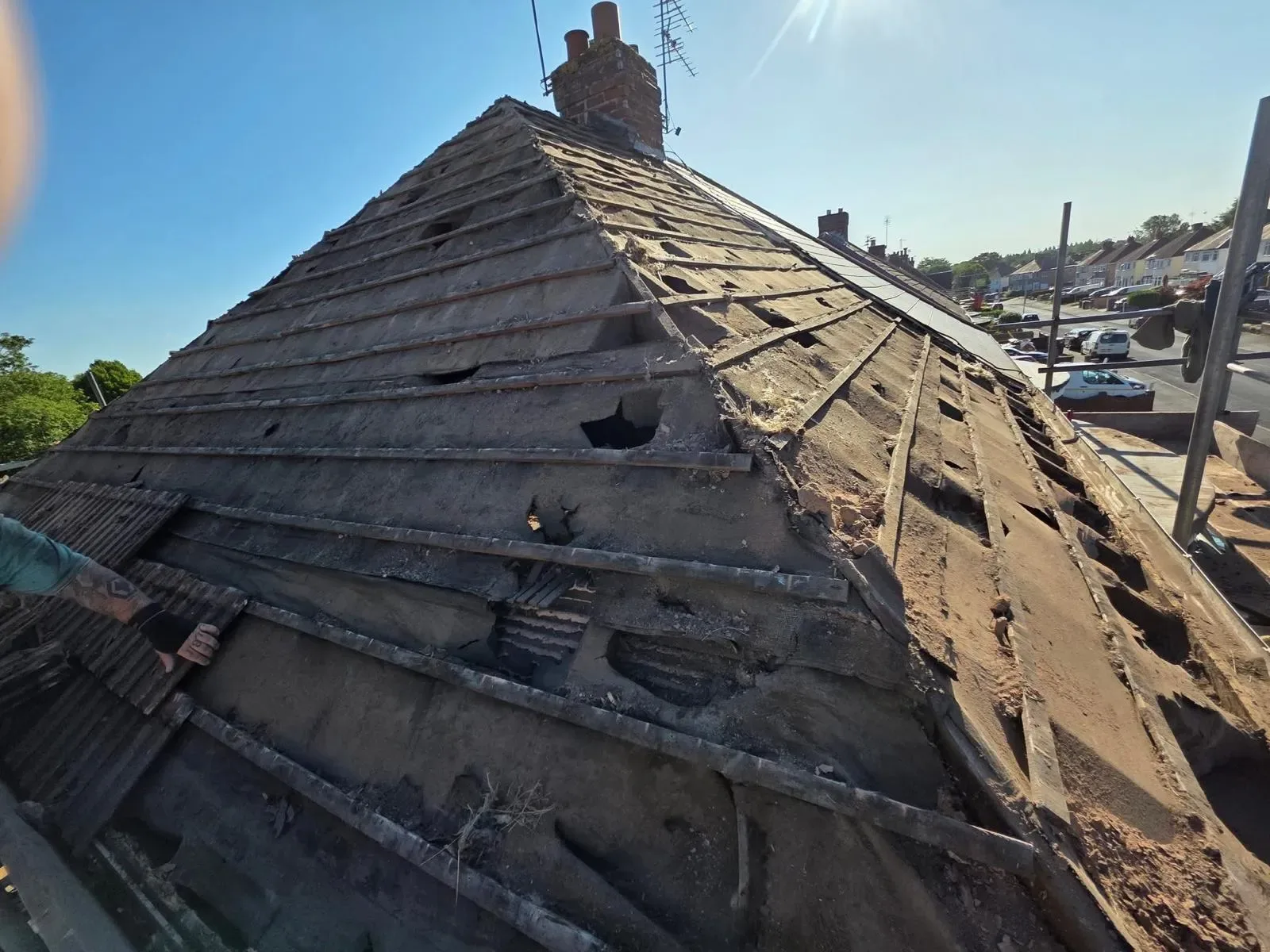 A hipped roof stripped and re-laid in dark concrete tile, image 11