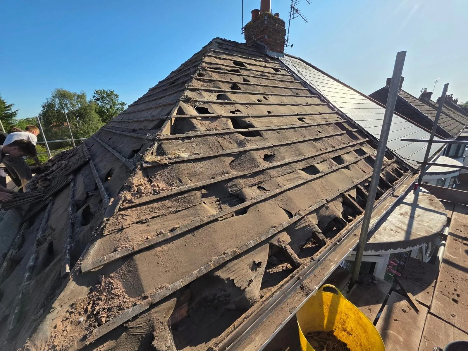 A hipped roof stripped and re-laid in dark concrete tile, image 12