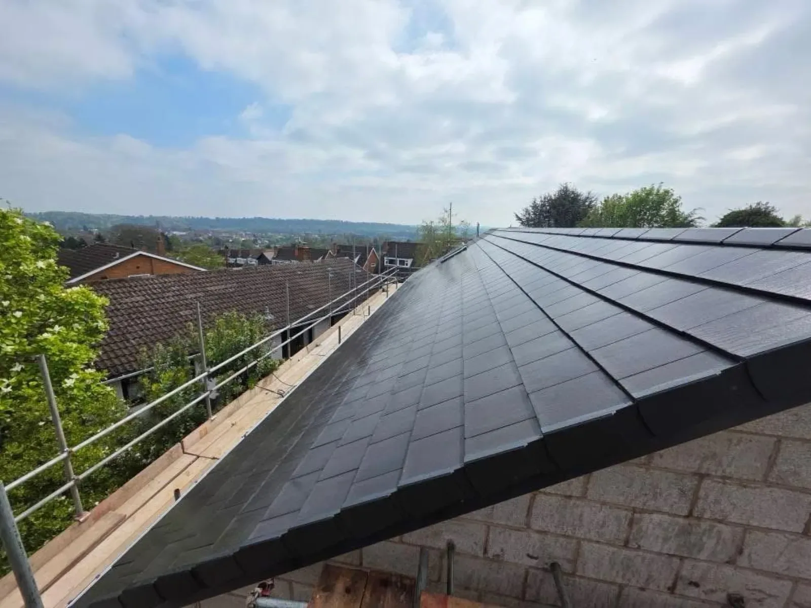 A new build roofed in dark concrete tile, with rooflights, image 4