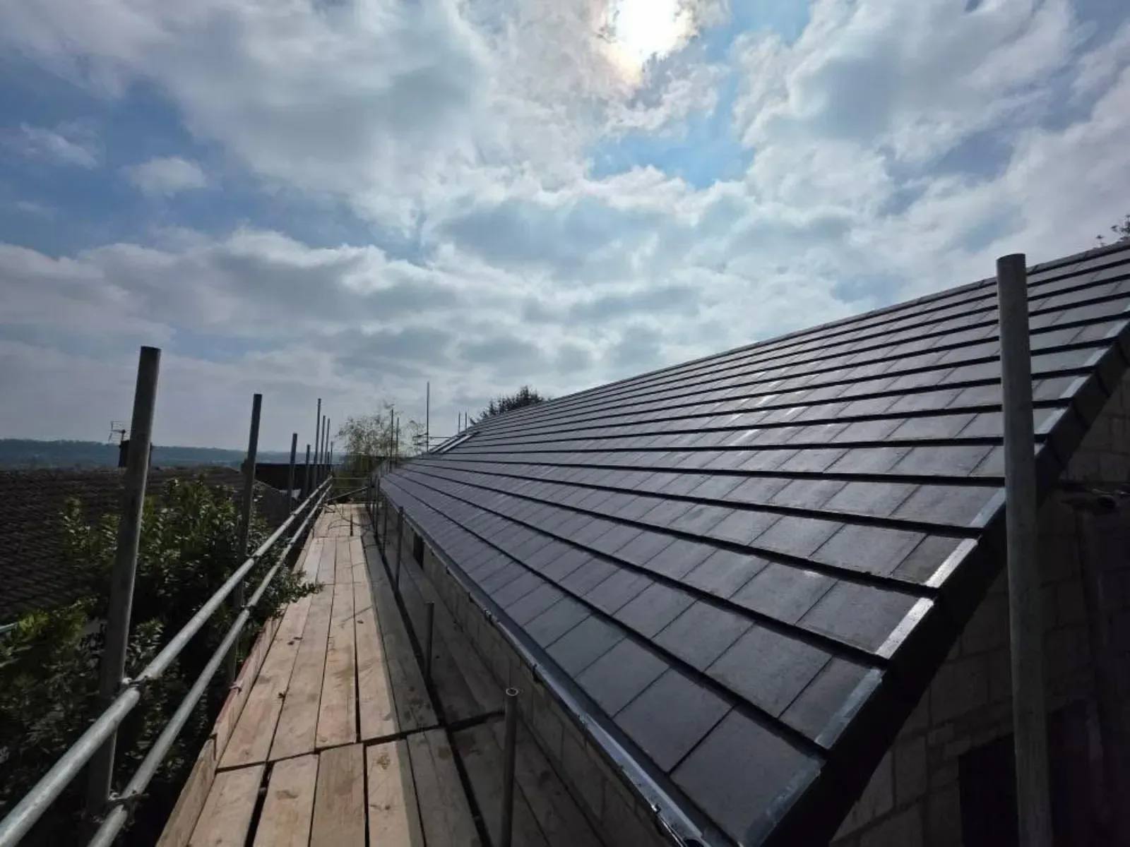 A new build roofed in dark concrete tile, with rooflights, image 3