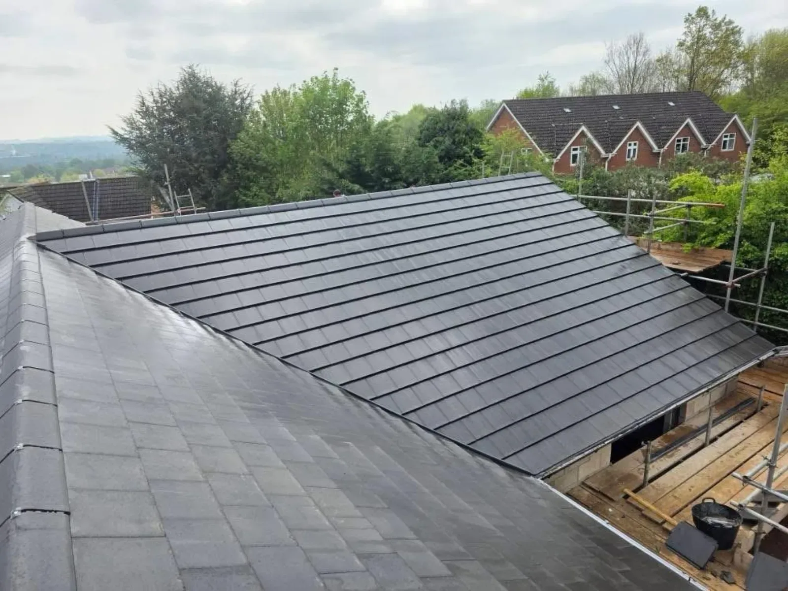 A new build roofed in dark concrete tile, with rooflights, image 11