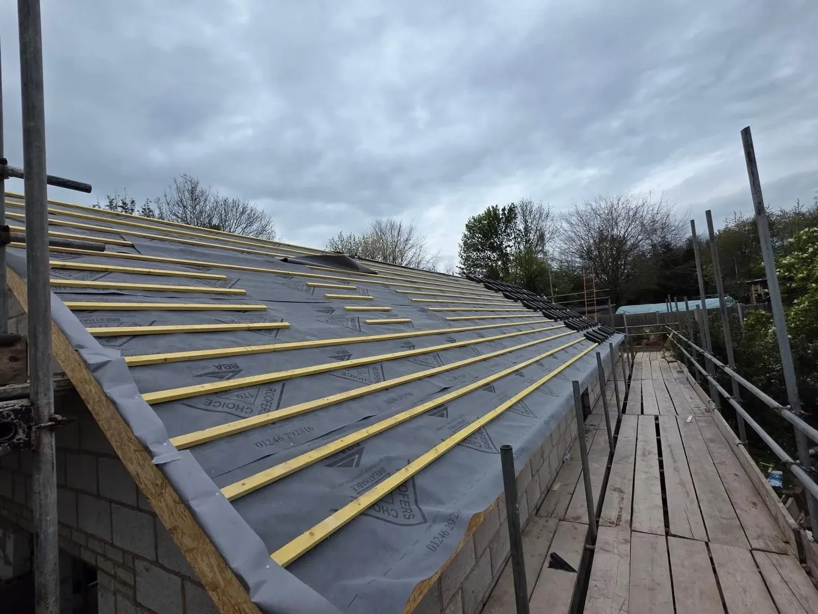 A new build roofed in dark concrete tile, with rooflights, image 18