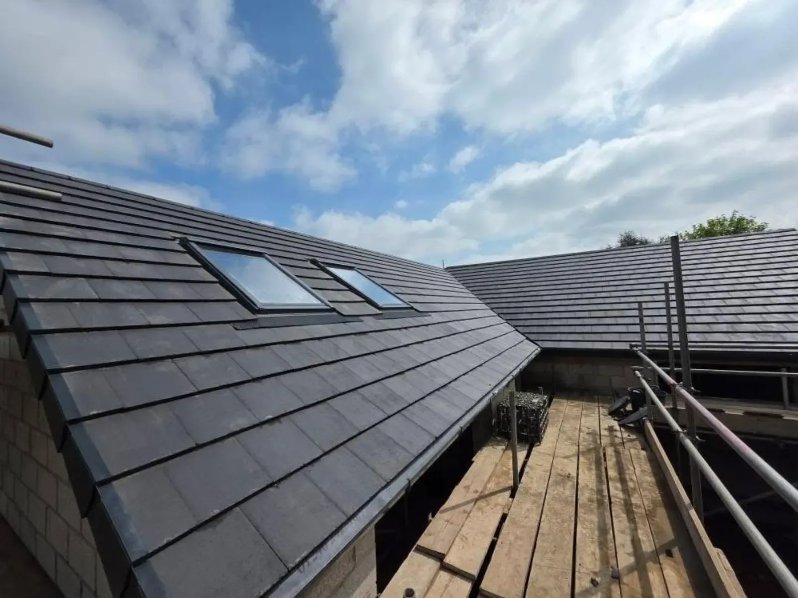 A new build roofed in dark concrete tile, with rooflights, image 2