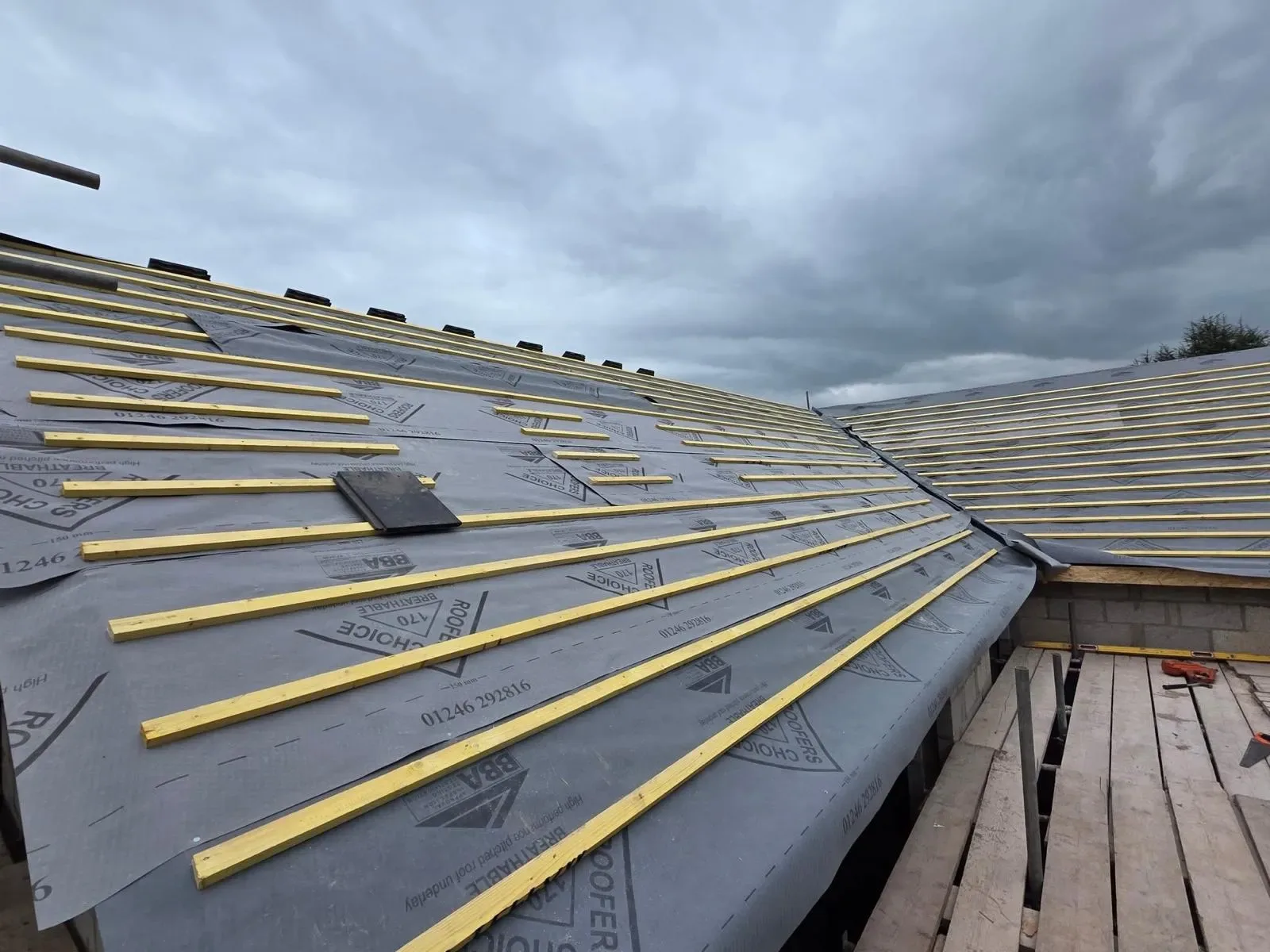 A new build roofed in dark concrete tile, with rooflights, image 19